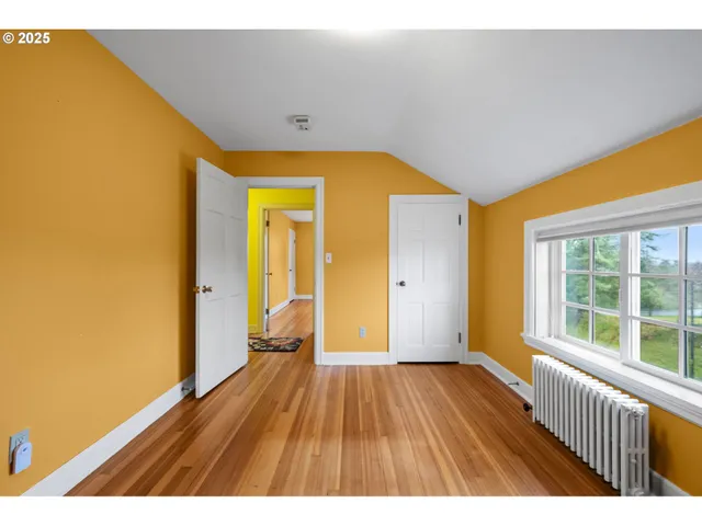 a view of hallway with wooden floor