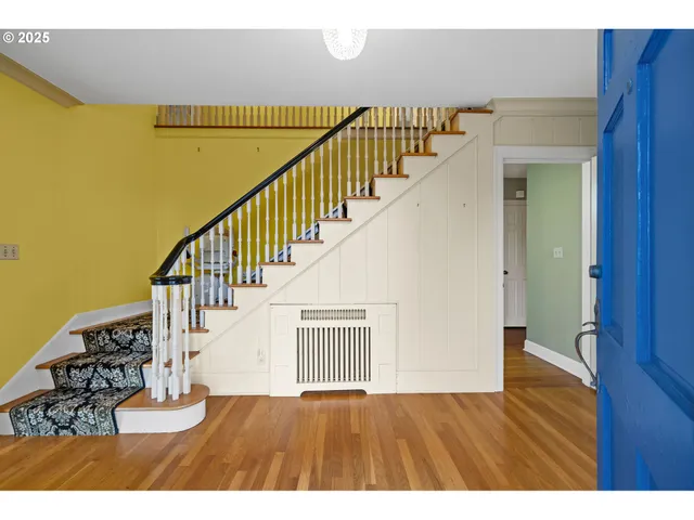 a view of an entryway with wooden floor
