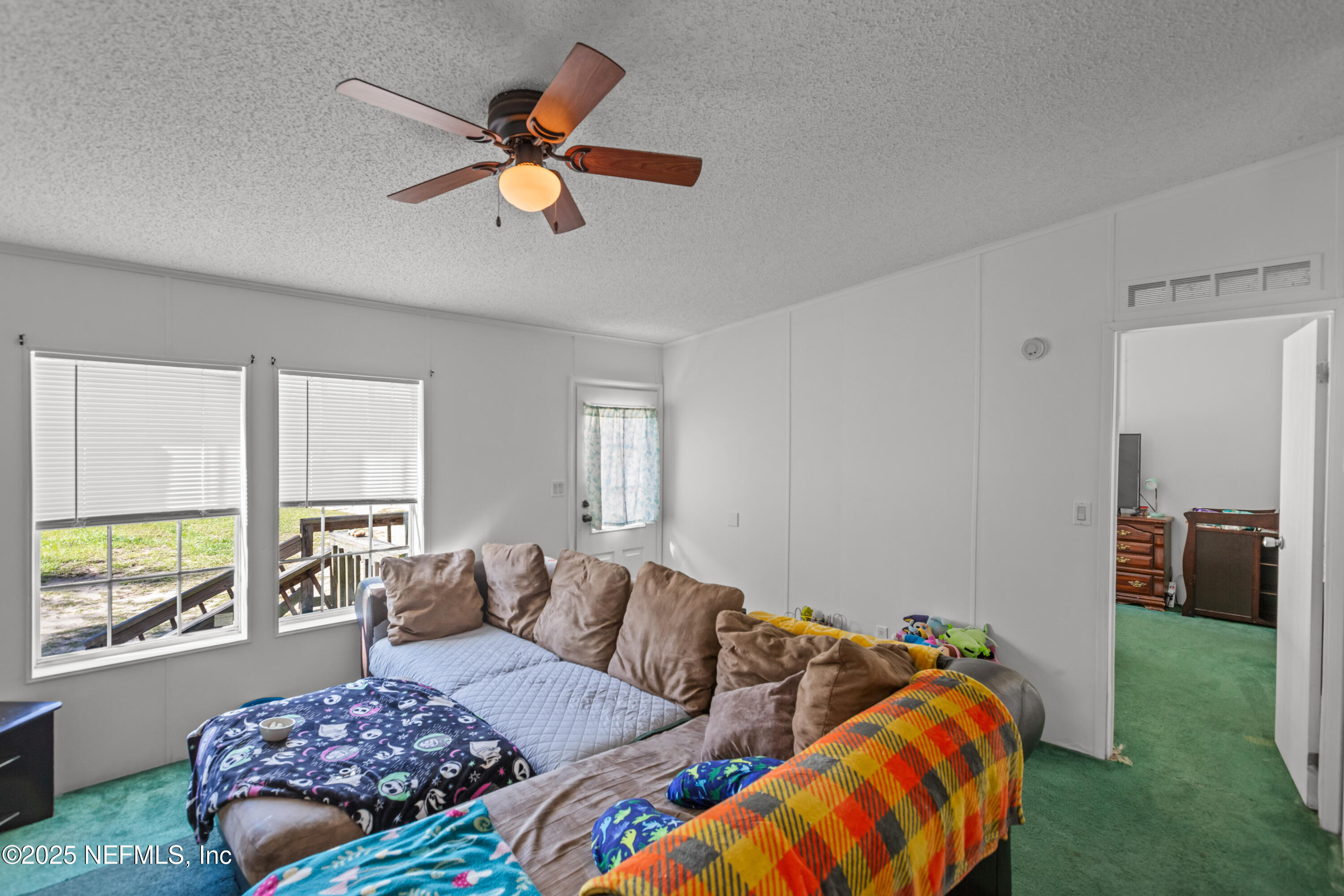 6279 Little Lake Geneva Road Keystone Heights, FL 32656 - Photo 11 of 45 a living room with furniture and a large window