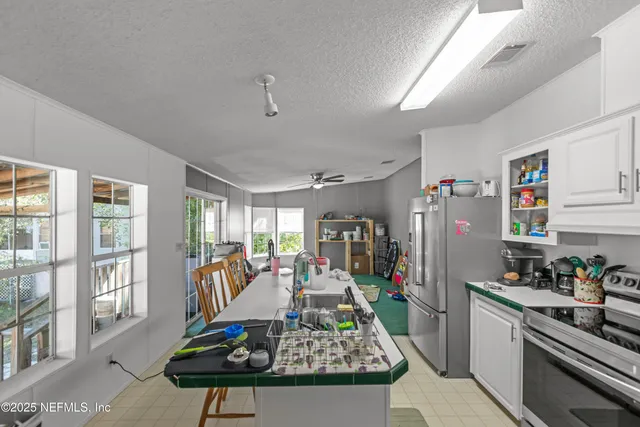 a living room with furniture a flat screen tv and a table