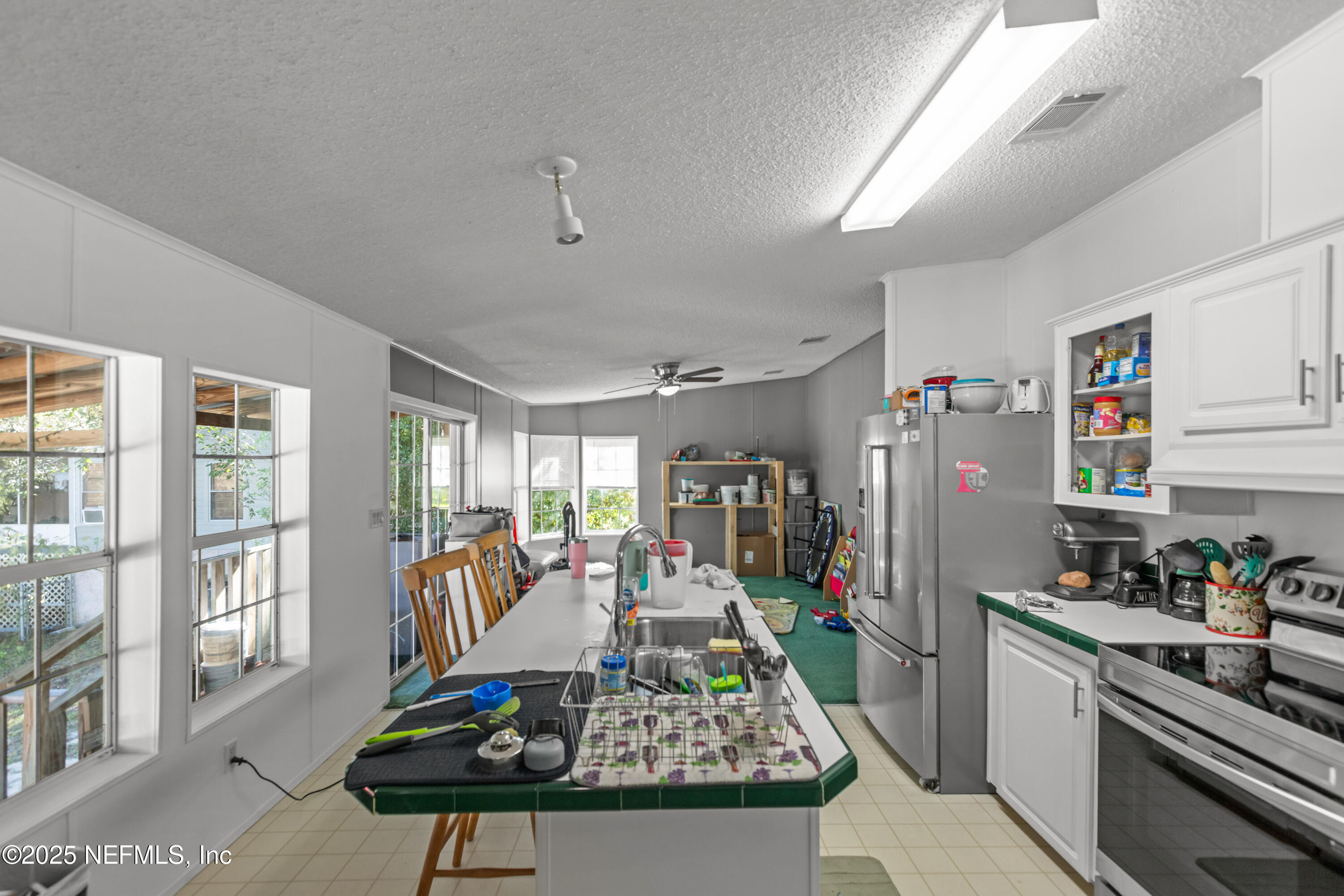 6279 Little Lake Geneva Road Keystone Heights, FL 32656 - Photo 13 of 45 a living room with furniture a flat screen tv and a table