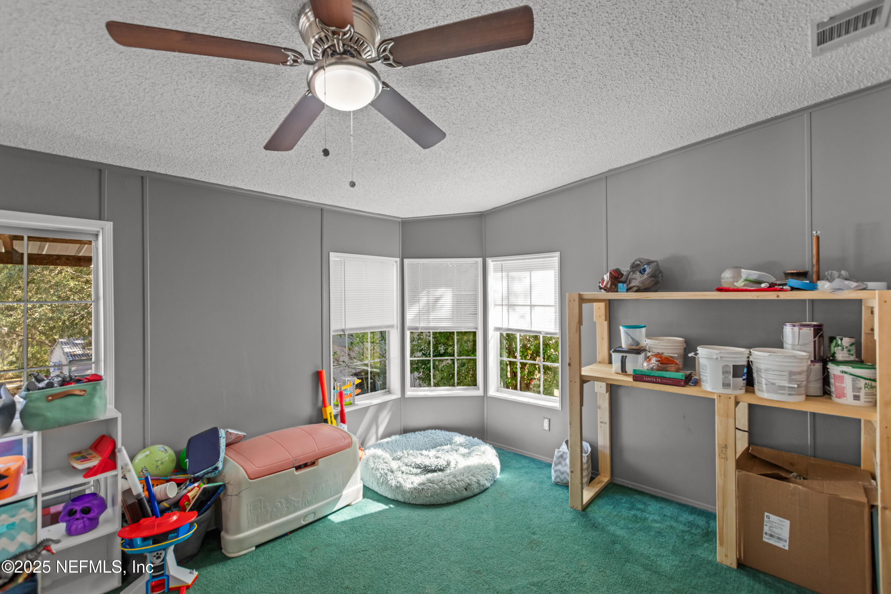 6279 Little Lake Geneva Road Keystone Heights, FL 32656 - Photo 14 of 45 a bedroom with a bed and a chandelier