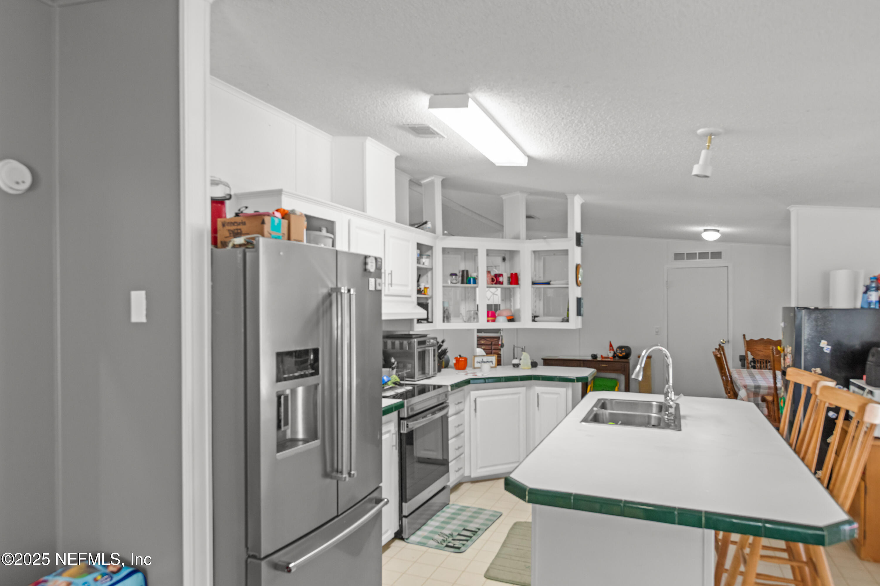 6279 Little Lake Geneva Road Keystone Heights, FL 32656 - Photo 17 of 45 a kitchen with stainless steel appliances a refrigerator and a sink