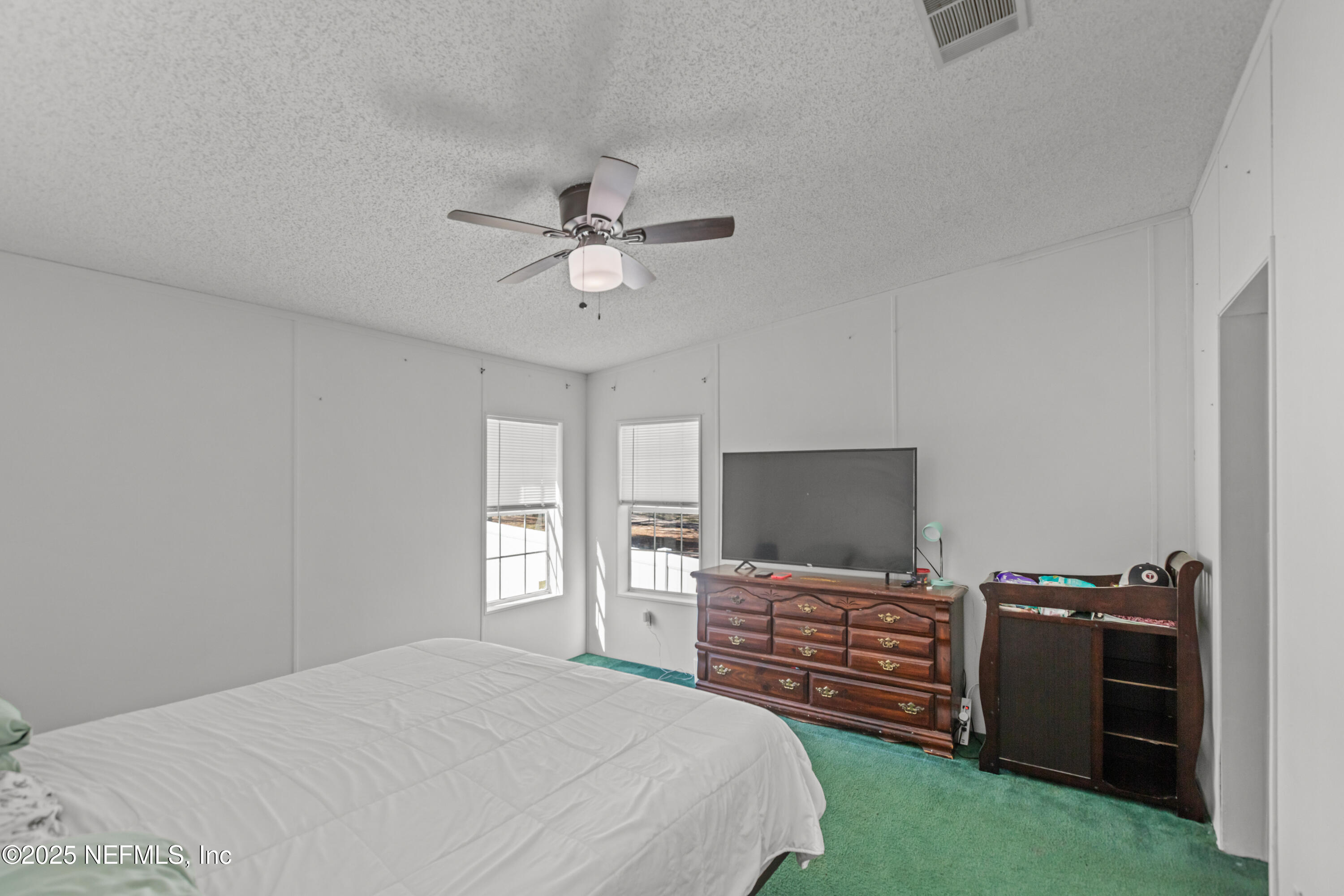 6279 Little Lake Geneva Road Keystone Heights, FL 32656 - Photo 19 of 45 a bedroom with a bed and a television