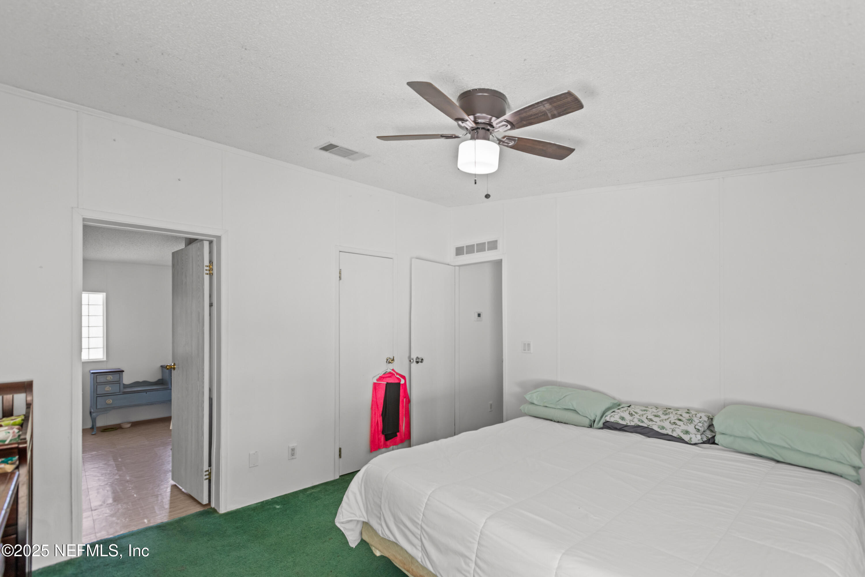 6279 Little Lake Geneva Road Keystone Heights, FL 32656 - Photo 20 of 45 a bedroom with a bed and a chandelier
