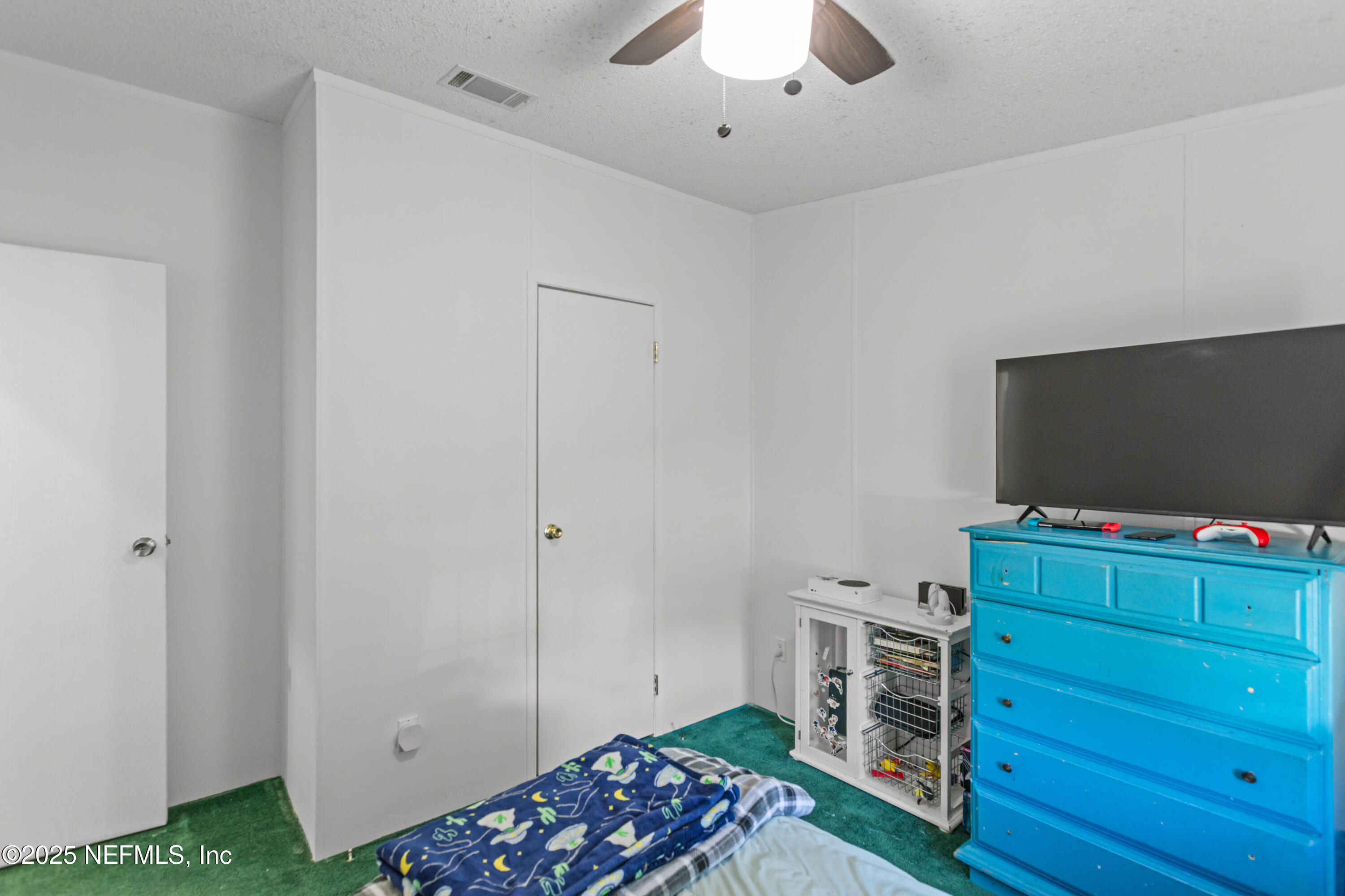 6279 Little Lake Geneva Road Keystone Heights, FL 32656 - Photo 28 of 45 a bedroom with a bed and flat screen tv