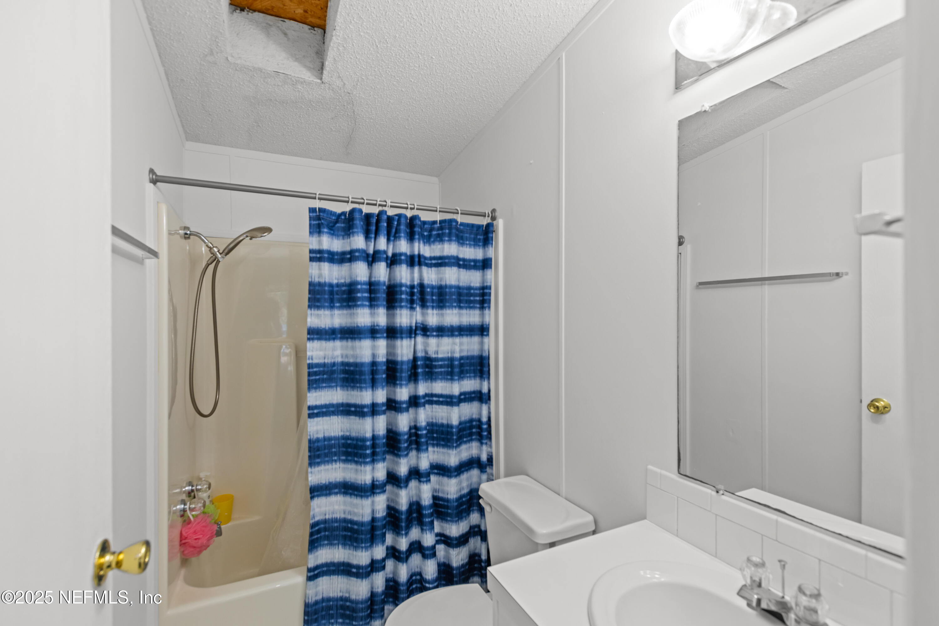 6279 Little Lake Geneva Road Keystone Heights, FL 32656 - Photo 29 of 45 a bathroom with a shower toilet and sink