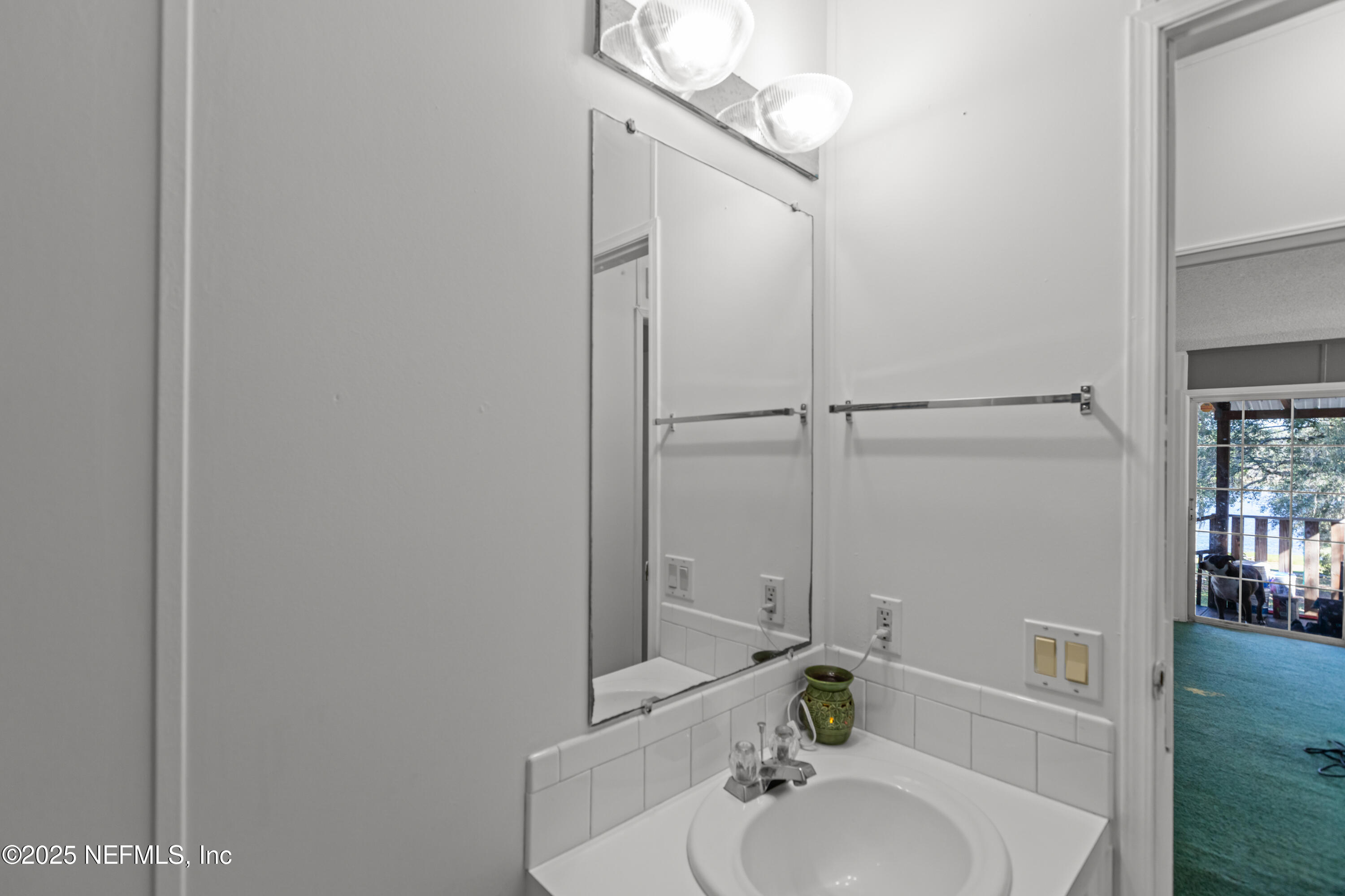 6279 Little Lake Geneva Road Keystone Heights, FL 32656 - Photo 30 of 45 a bathroom with a sink and a mirror