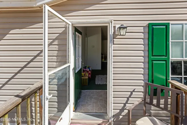 a view of a porch with a table and chairs