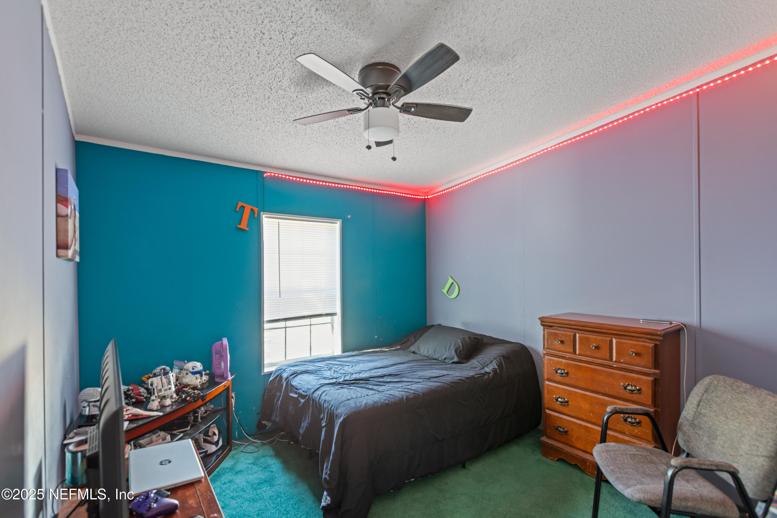 6279 Little Lake Geneva Road Keystone Heights, FL 32656 - Photo 32 of 45 a bedroom with a bed and a chandelier