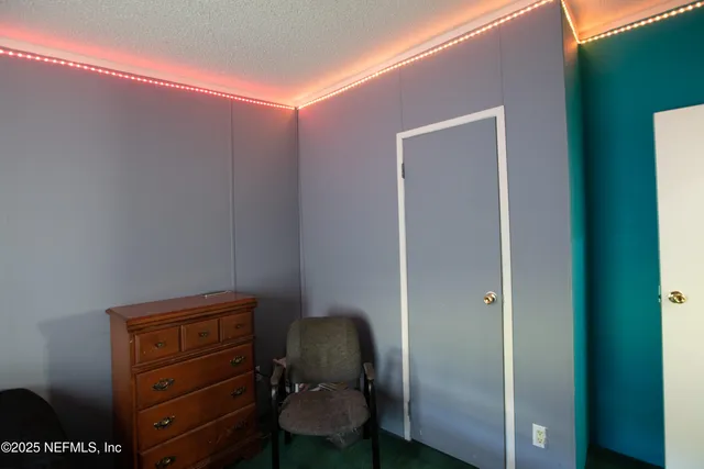 a room with a chair and a dresser