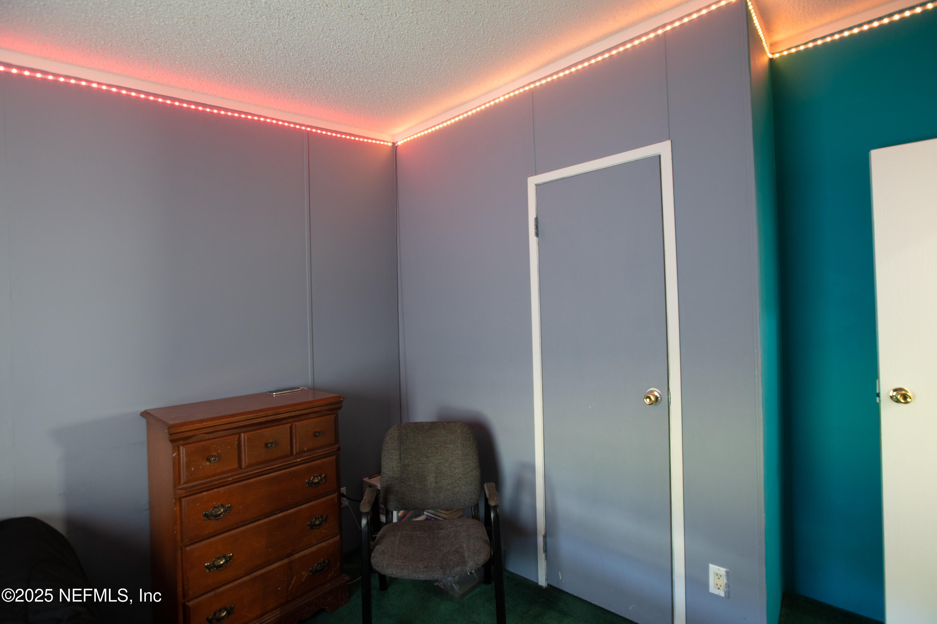 6279 Little Lake Geneva Road Keystone Heights, FL 32656 - Photo 33 of 45 a room with a chair and a dresser