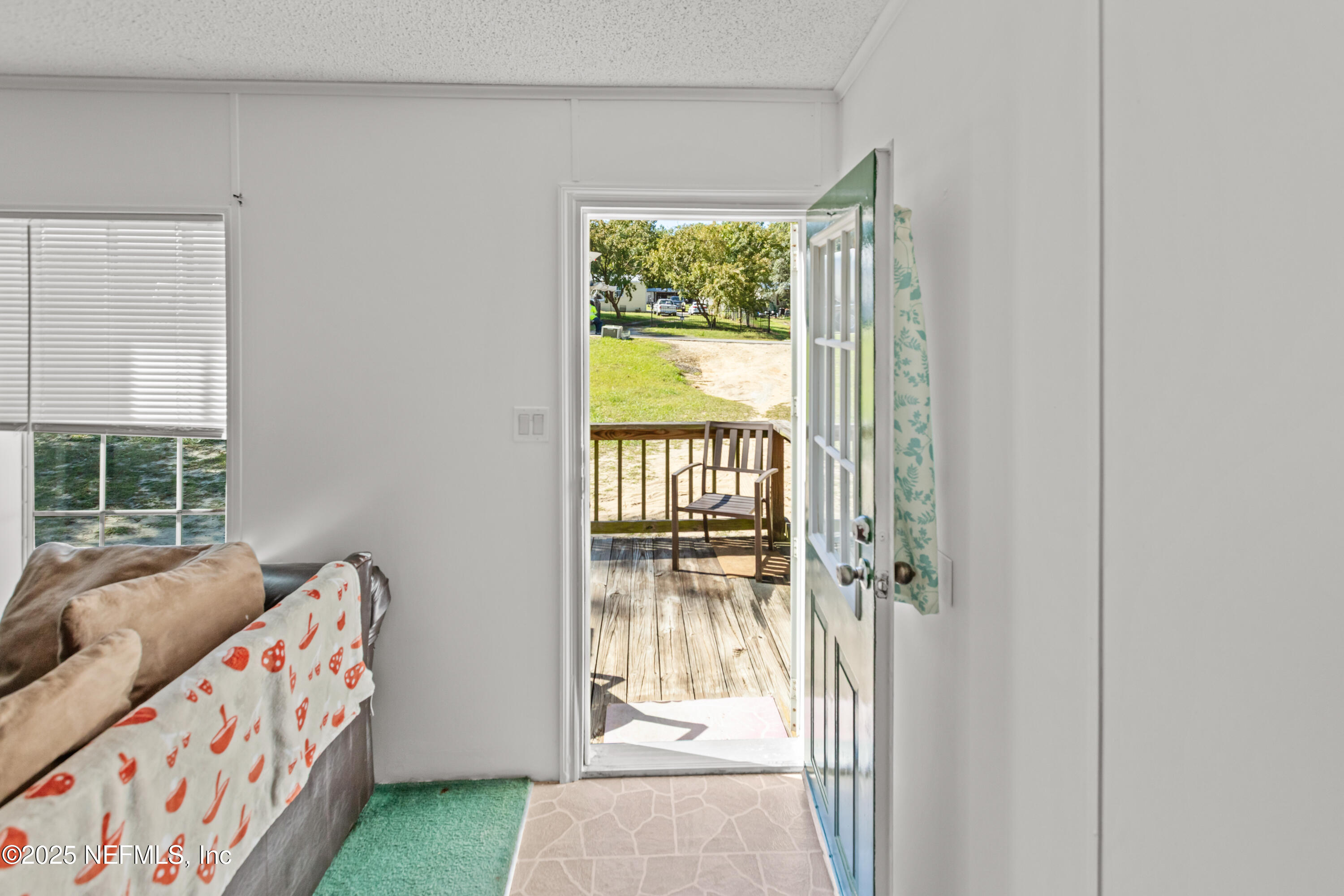 6279 Little Lake Geneva Road Keystone Heights, FL 32656 - Photo 4 of 45 a bedroom with furniture and a window