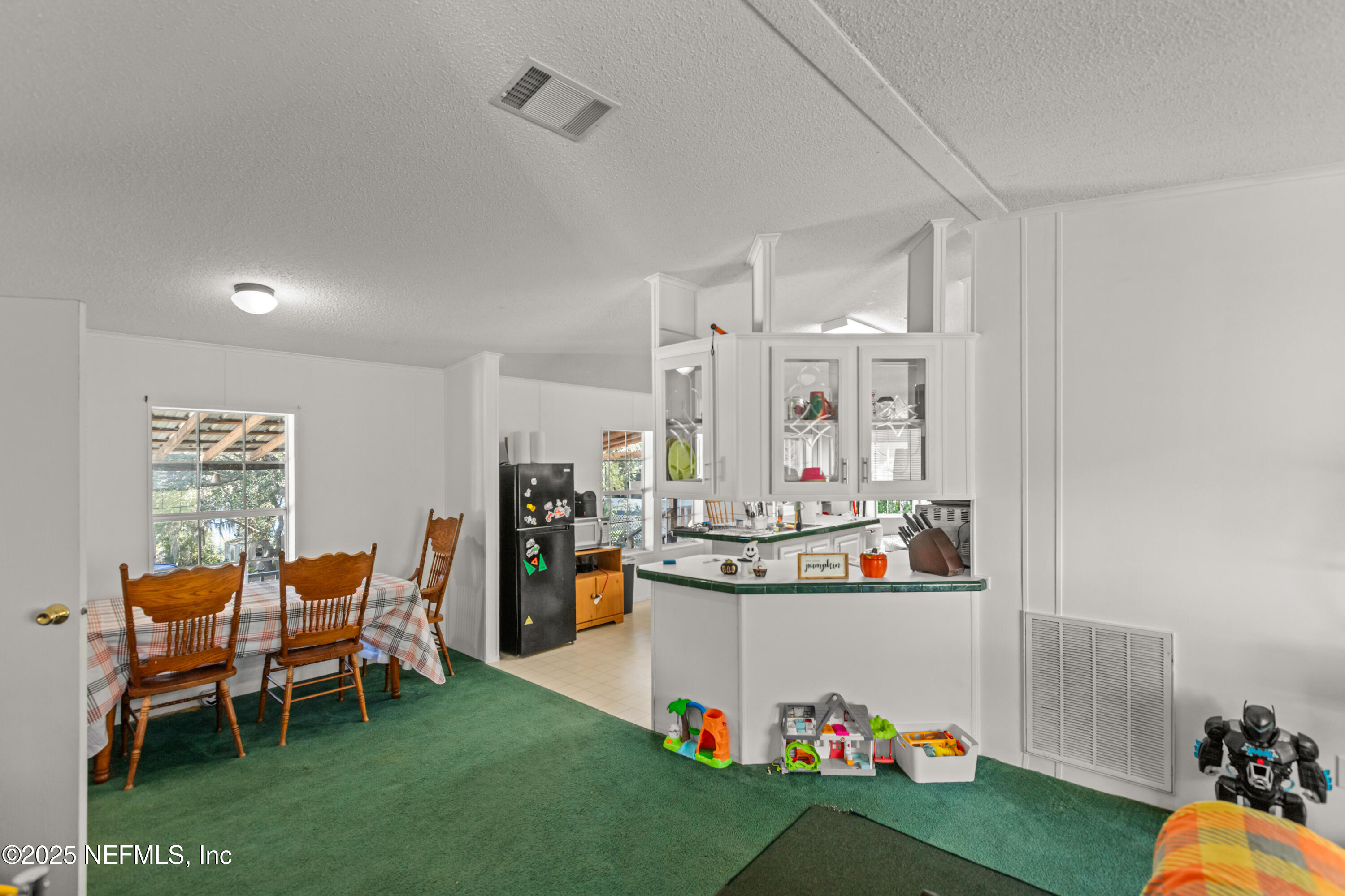 6279 Little Lake Geneva Road Keystone Heights, FL 32656 - Photo 8 of 45 a living room with furniture and a dining table with chairs