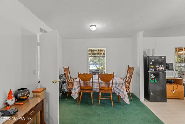 a dining room with furniture and a window