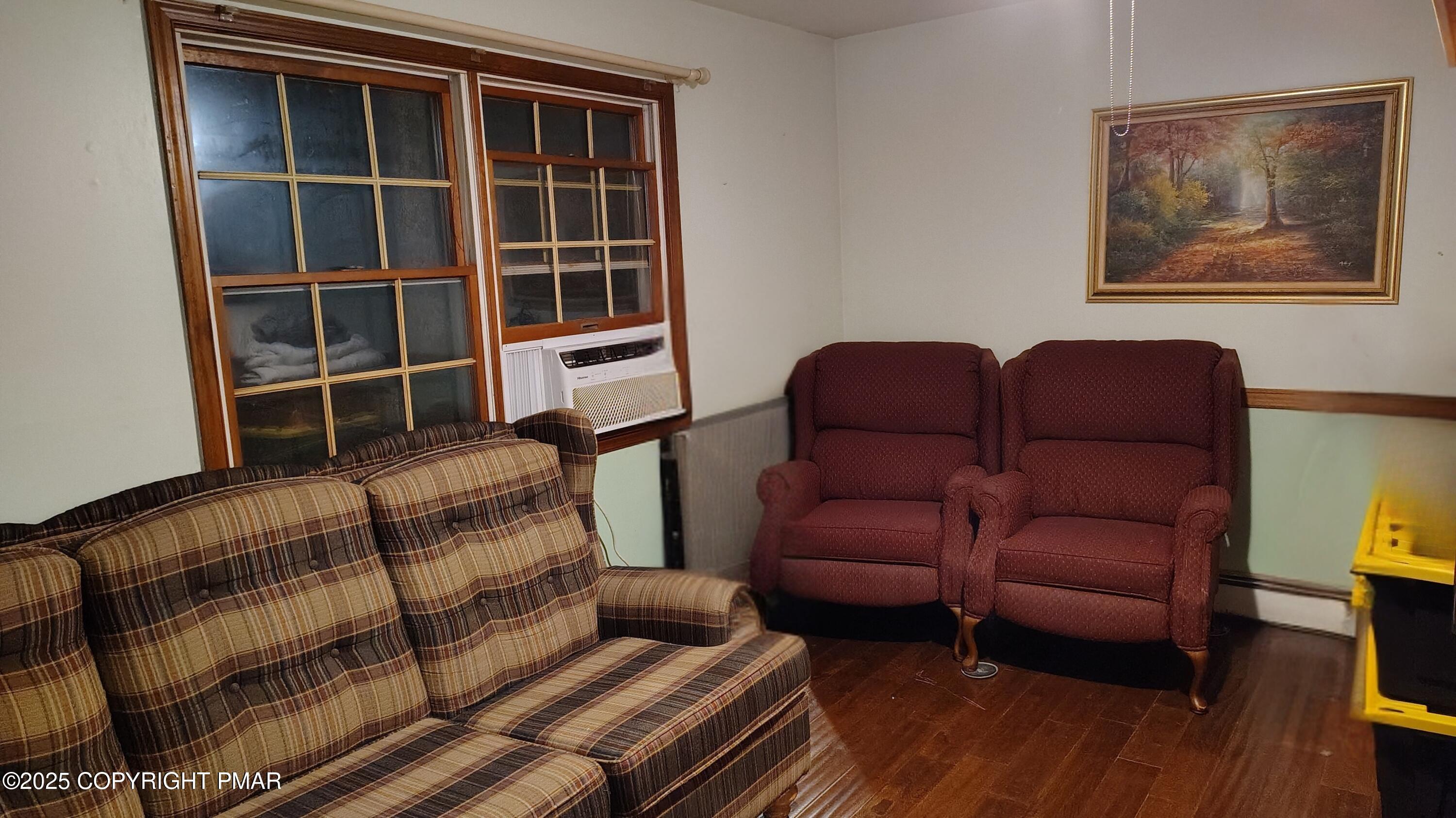 587 Long Mountain Road Effort, PA 18330 - Photo 11 of 29 a blue couch sitting in a living room next to a window