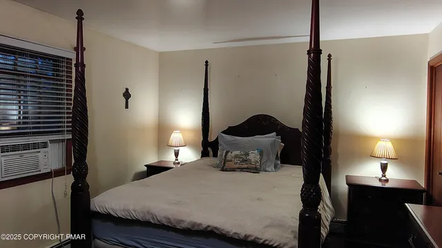 a bedroom with a bed and a lamp on table