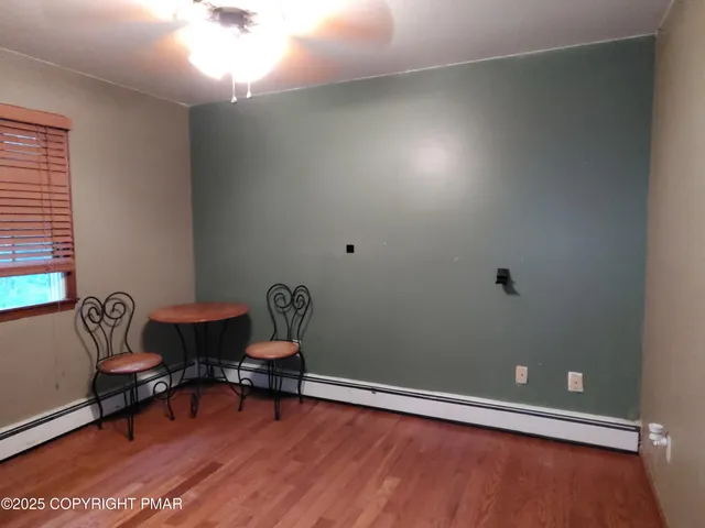 a workspace room with wooden floor and lounge chair