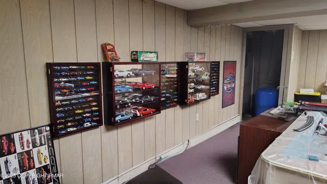 a front view of a house with garden and trees