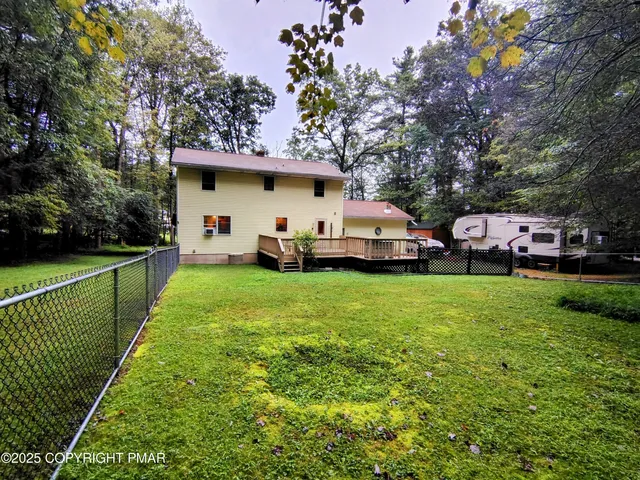 a front view of a house with chair and tables
