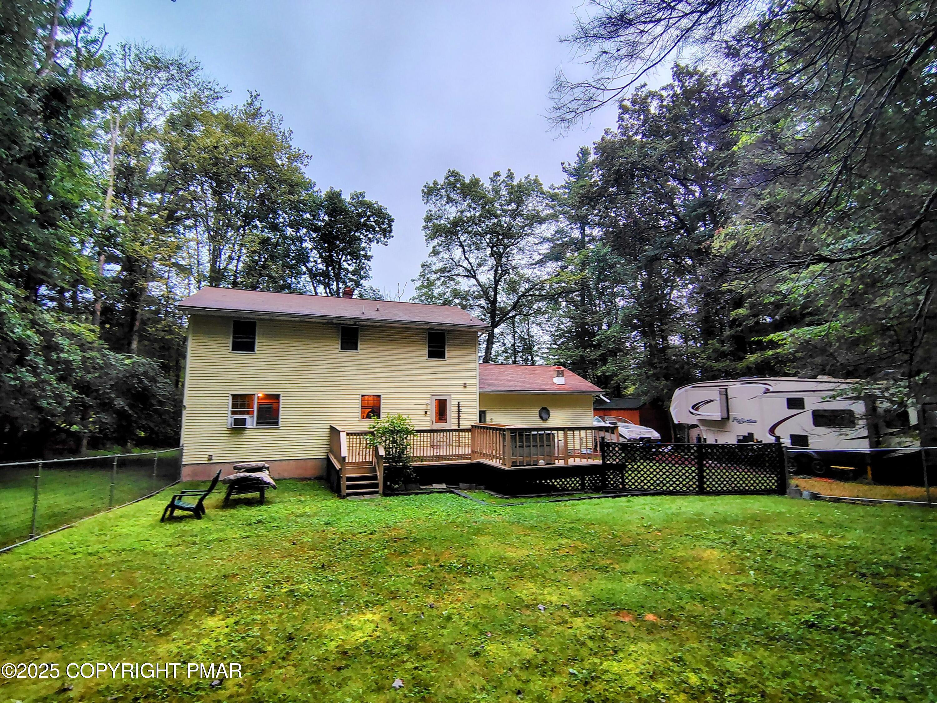 587 Long Mountain Road Effort, PA 18330 - Photo 21 of 29 a front view of a house with garden and trees