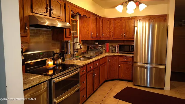 a kitchen with wooden cabinets and a sink