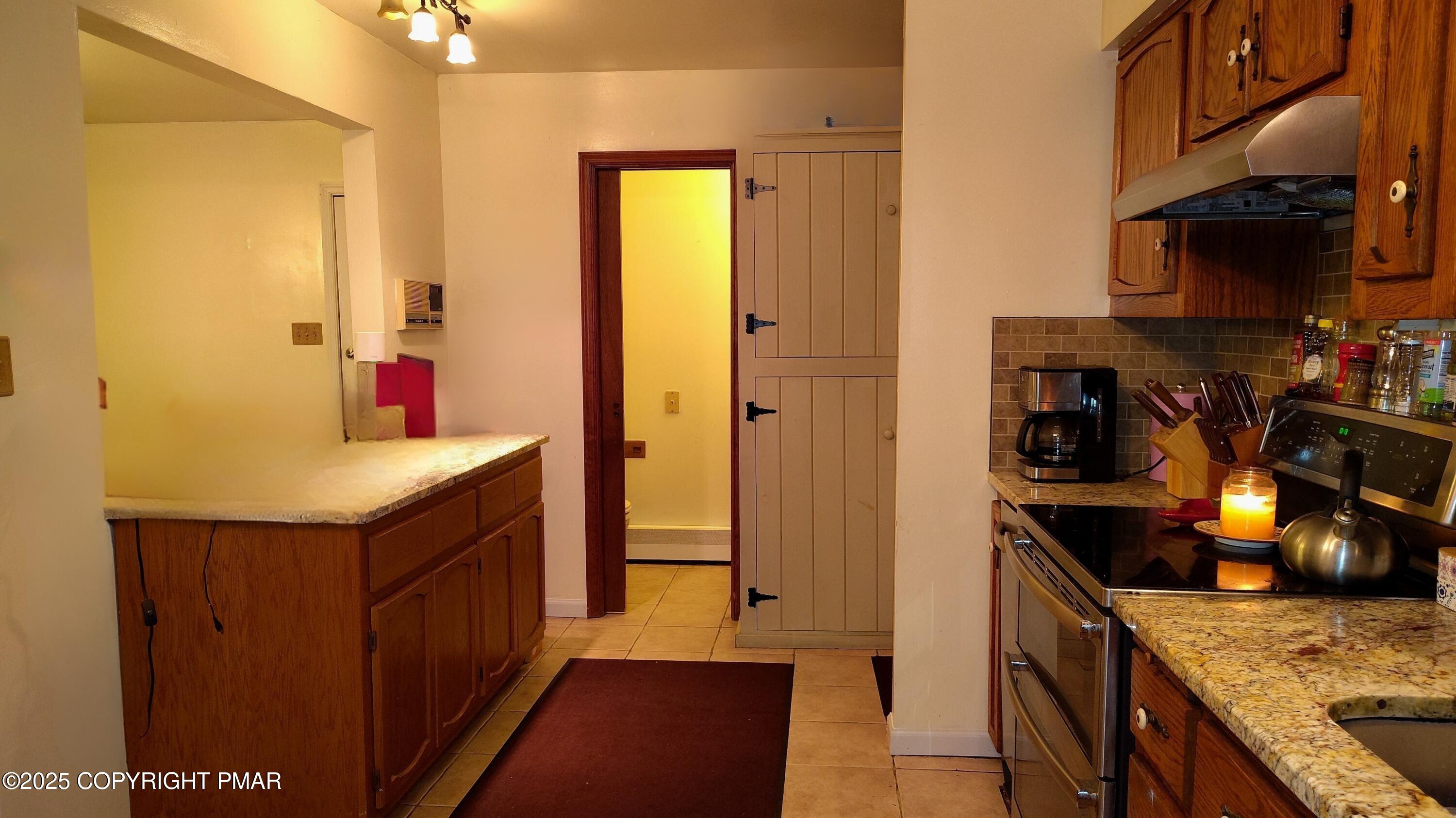 587 Long Mountain Road Effort, PA 18330 - Photo 7 of 29 a kitchen with stainless steel appliances granite countertop a sink and a refrigerator