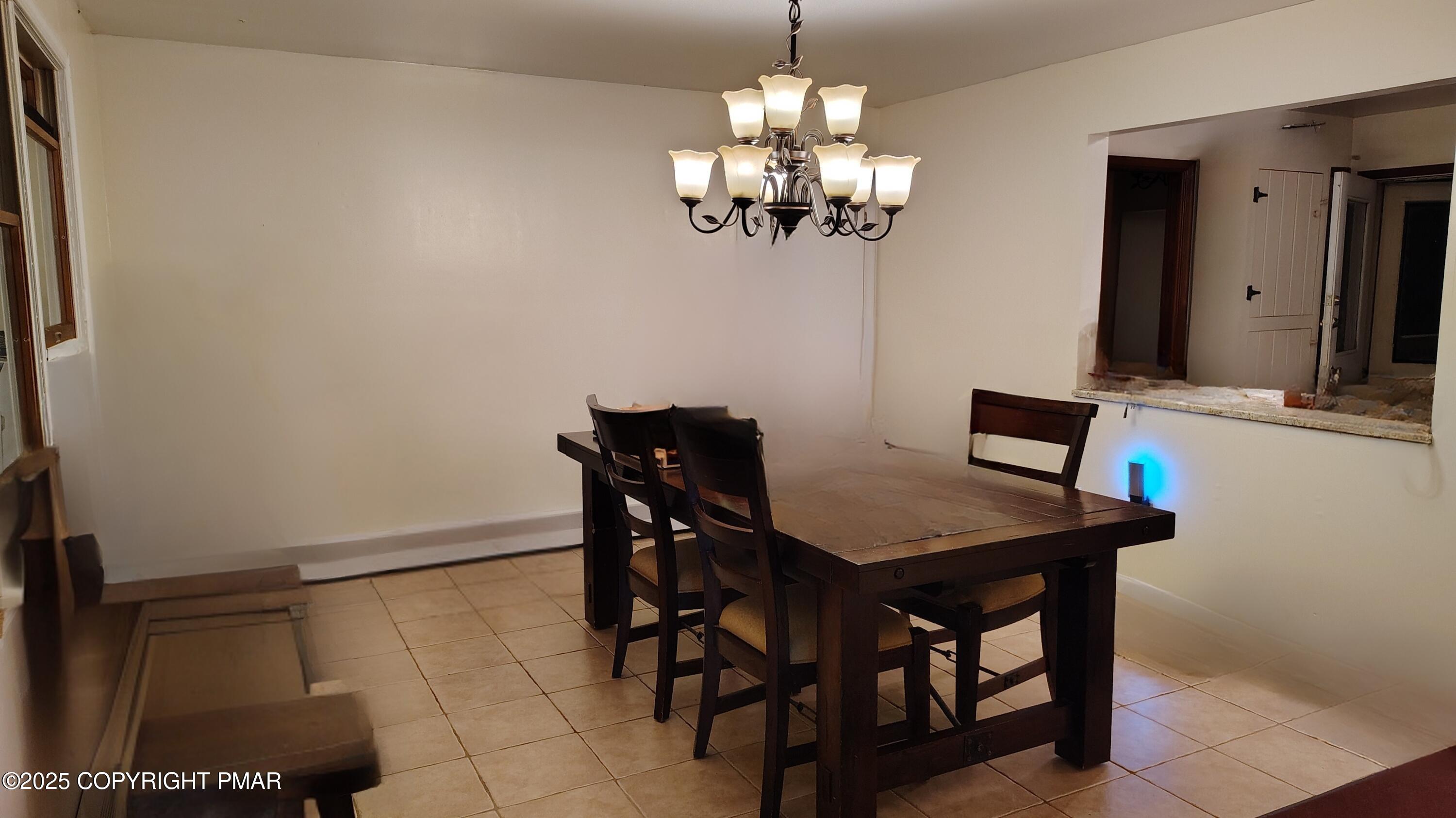 587 Long Mountain Road Effort, PA 18330 - Photo 8 of 29 a view of a dining room with furniture and chandelier