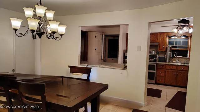 a view of a dining room with furniture and chandelier