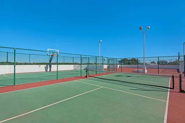 a view of a tennis court with chairs