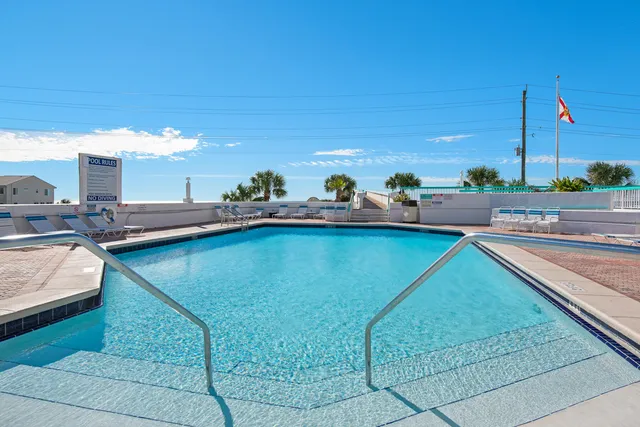 a view of a swimming pool with outdoor seating