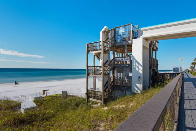 a view of a door with a potted plant and a sign on the wall