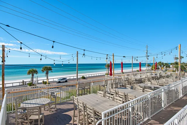 a view of a patio with dining table and chairs under an umbrella
