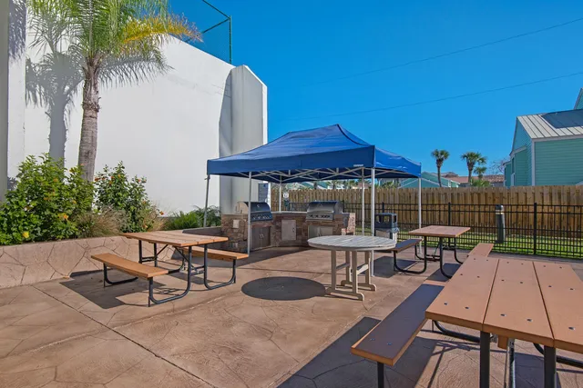 a living room with furniture a flat screen tv and large window