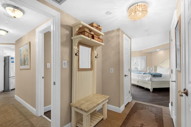 a bedroom with a bed and a flat tv screen on dresser