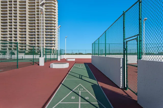 a view of a tennis ground with a large window