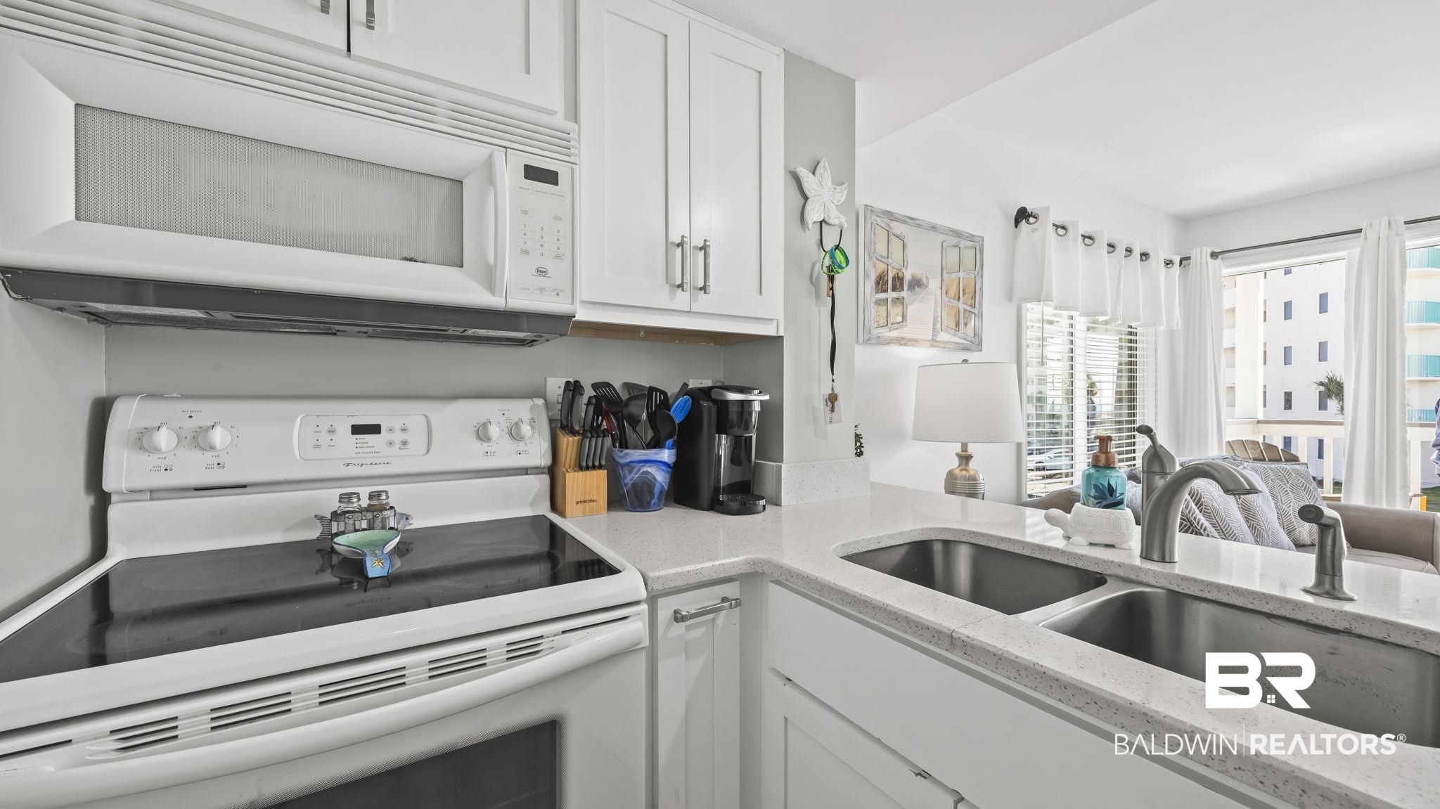 497 Plantation Road, Unit 1247 Gulf Shores, AL 36542 - Photo 29 of 29 Kitchen with white appliances, light stone countertops, white cabinets, and open floor plan