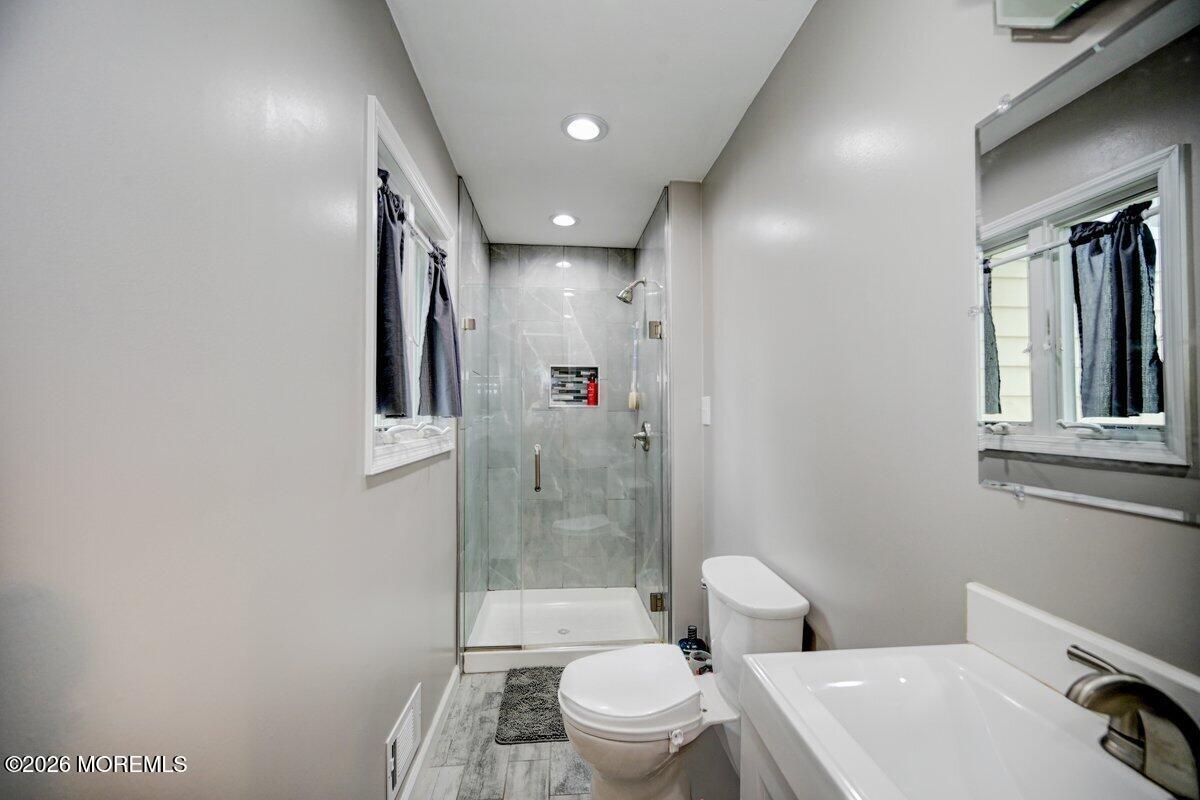 6 Meadowbrook Drive Howell, NJ 07731 - Photo 14 of 24 a bathroom with a toilet a sink and a shower