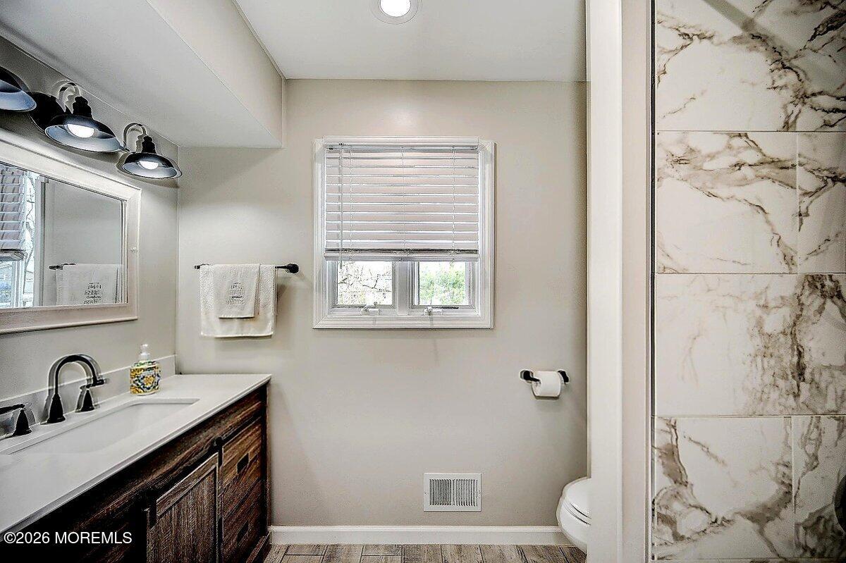 6 Meadowbrook Drive Howell, NJ 07731 - Photo 17 of 24 a bathroom with a granite countertop sink a toilet a mirror and shower
