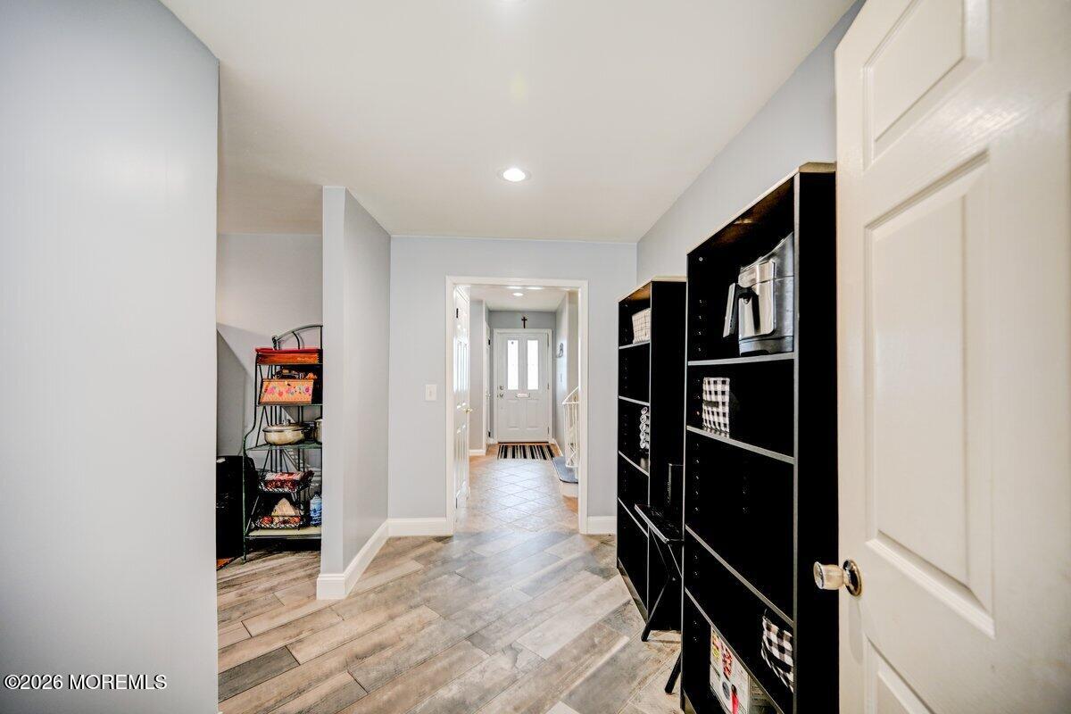 6 Meadowbrook Drive Howell, NJ 07731 - Photo 7 of 24 a view of a hallway with wooden floor and closet