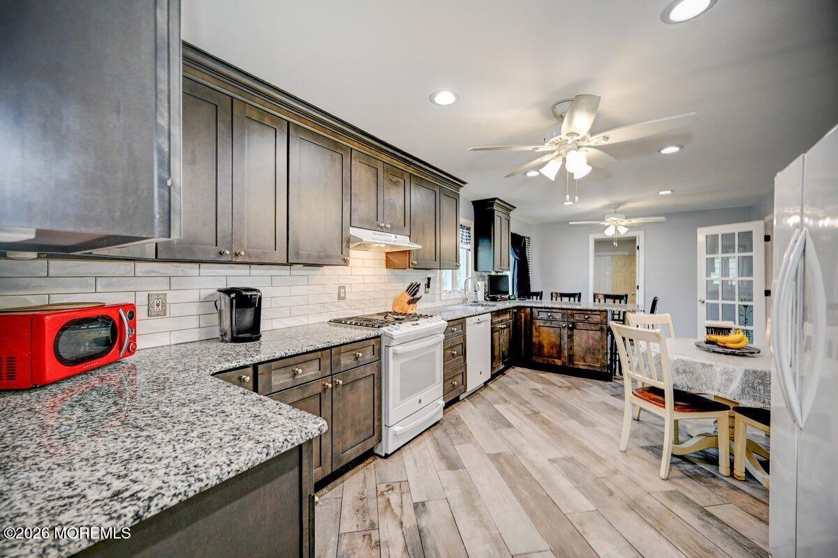 6 Meadowbrook Drive Howell, NJ 07731 - Photo 8 of 24 a large kitchen with stainless steel appliances granite countertop a lot of counter space and wooden floors