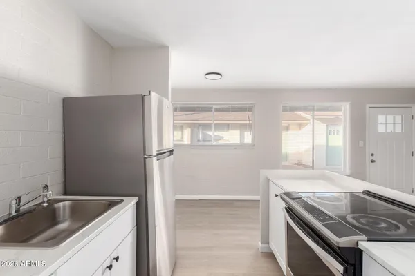 a kitchen with a refrigerator sink and stove