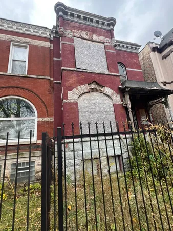 a view of a brick house with large windows