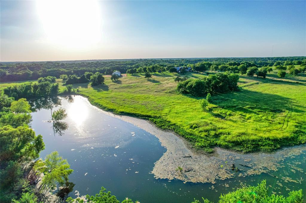 1922 A Bethel-Cannon Road Whitewright, TX 75491 - Photo 24 of 40 Expansive natural landscape featuring a substantial body of water, lush green fields, and mature trees