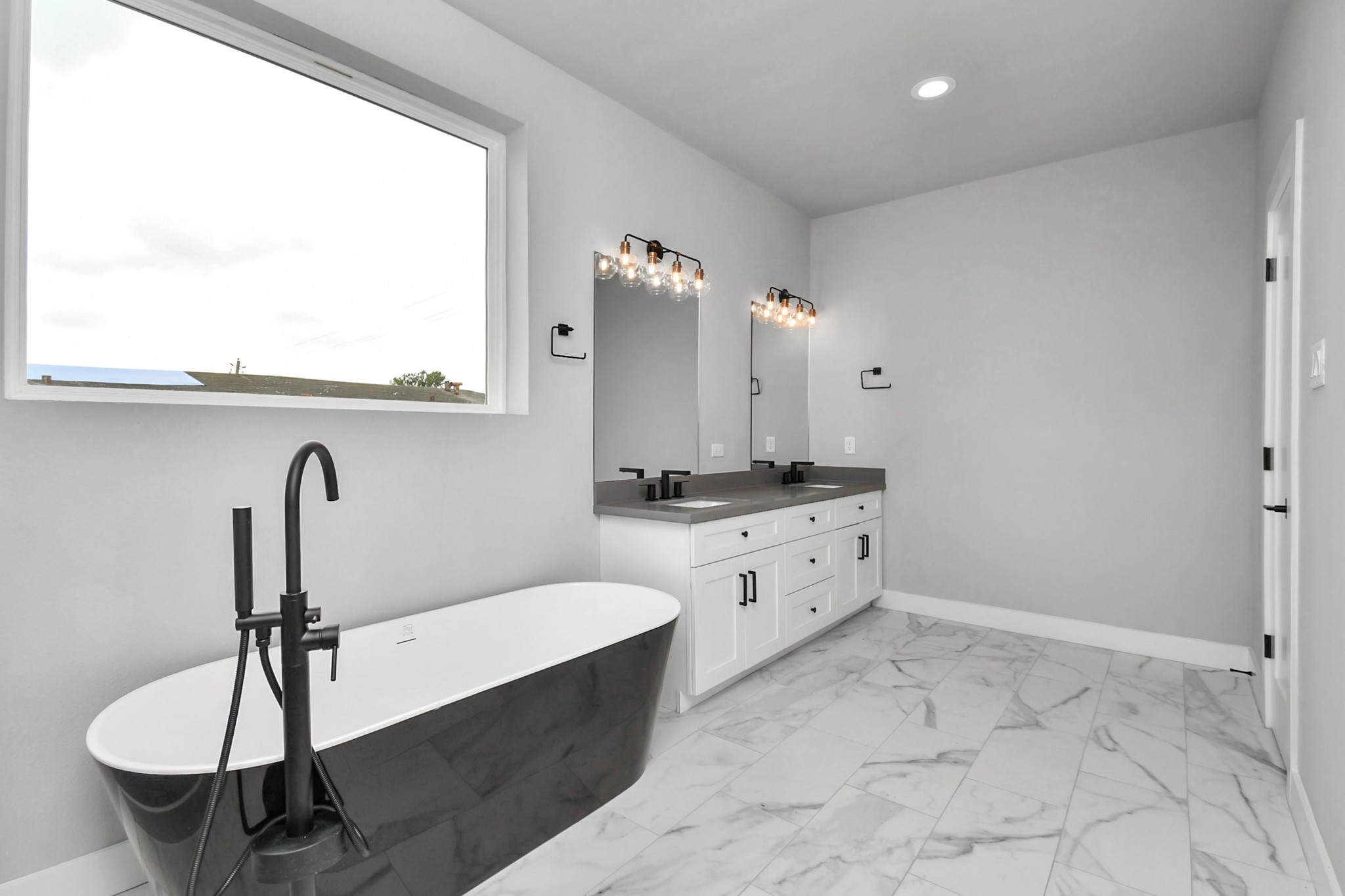 6817 Peerless Street Houston, TX 77021 - Photo 13 of 31 a bathroom with a double vanity sink a mirror and bathtub