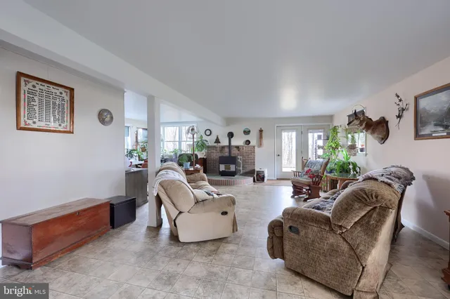 a view of a livingroom with furniture and a window