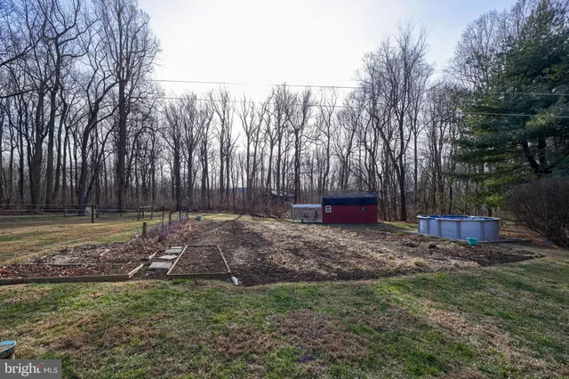 a view of a house with a yard covered in snow