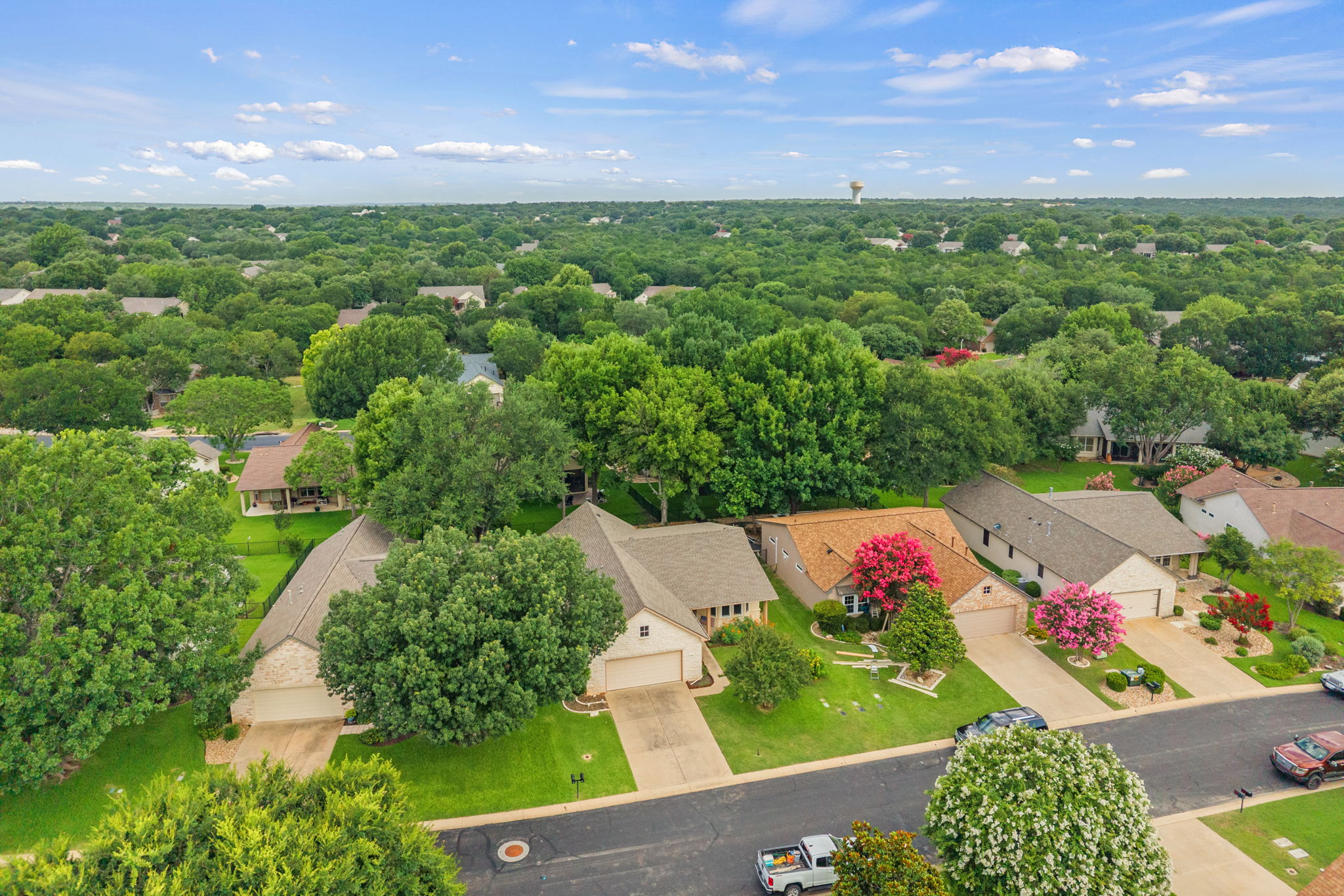 118 Bass Street Georgetown, TX 78633 - Photo 5 of 40 An aerial perspective reveals a harmonious suburban community with lush green trees and manicured yards.