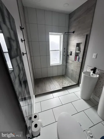 a view of a living room and bathroom with a toilet