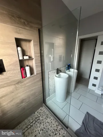 a view of walk in closet with wooden floor